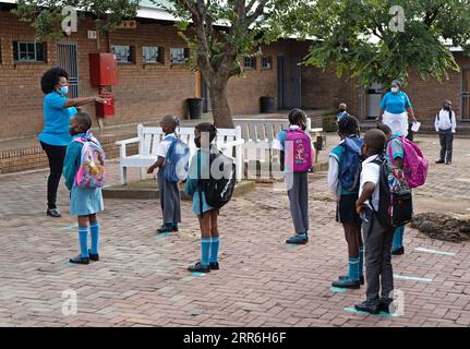 210216 -- JOHANNESBURG, Feb. 16, 2021 -- Pupils wait to enter the classroom at a primary school in Johannesburg, South Africa, Feb. 15, 2021. Over 20,000 public schools in South Africa were reopened in accordance with strict adherence to the COVID-19 protocol on Monday. Photo by /Xinhua SOUTH AFRICA-JOHANNESBURG-COVID-19-PUBLIC SCHOOL-REOPEN MatthewxMartinxBrink PUBLICATIONxNOTxINxCHN Stock Photo