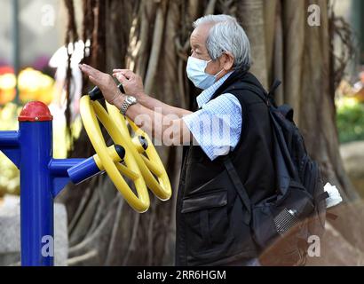 210216 -- HONG KONG, Feb. 16, 2021 -- A man wearing a face mask takes exercise outdoors in Hong Kong, south China, Feb. 16, 2021. Hong Kong will loosen social distancing measures from Thursday to allow some entertainment venues to reopen after daily new COVID-19 cases remained at single digit on Tuesday. Eight new infections were reported by Hong Kong s Center for Health Protection on Tuesday, dropping further from nine cases on Monday and marking the lowest level in about three months. Lo Ping Fai CHINA-HONG KONG-COVID-19-CASESCN LuxBinghui PUBLICATIONxNOTxINxCHN Stock Photo