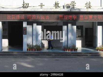 210220 -- FUZHOU, Feb. 20, 2021 -- A staff member sprays disinfectant on the corridor of a teaching building of a middle school in Fuzhou City, southeast China s Fujian Province, Feb. 20, 2021. Schools and kindergartens in Fuzhou City recently conduct disinfection work to prepare for the upcoming new semester.  CHINA-FUJIAN-SCHOOL-DISINFECTION CN SongxWeiwei PUBLICATIONxNOTxINxCHN Stock Photo