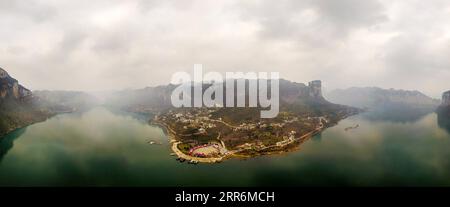 210222 -- QIANXI, Feb. 22, 2021 -- Aerial panoramic view of Huawu Village is seen in Qianxi County of Bijie City, southwest China s Guizhou Province, Feb. 21, 2021. Located in the deep mountainous area of Xinren Miao Township of Guizhou, Huawu Village is famous for its amazing landscapes. In recent years, with the efforts of local government, the village develops planting, cultivation, and tourism while relocating poverty-stricken people. Nowadays Huawu has taken on a new look in the new year, with various industries greeting booming development.  CHINA-GUIZHOU-HUAWU VILLAGE-DEVELOPMENT CN Yan Stock Photo