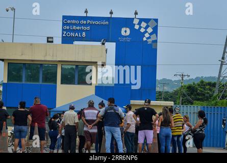Relatives of inmates wait for news outside El Inca prison following a ...