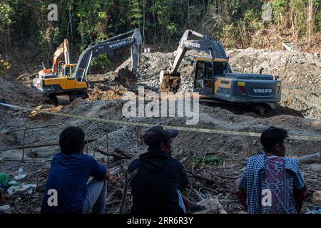 210225 -- JAKARTA, Feb. 25, 2021 -- Excavators search for victims after landslides at a gold mine in Parigi Mutong district of Central Sulawesi, Indonesia, Feb. 25, 2021. Five bodies have been recovered and about 70 others were reported missing following landslides at a gold mine in Indonesia s Central Sulawesi province on Wednesday afternoon, a disaster agency official said on Thursday. Photo by /Xinhua INDONESIA-CENTRAL SULAWESI-ILLEGAL GOLD MINING-LANDSLIDE Opan PUBLICATIONxNOTxINxCHN Stock Photo