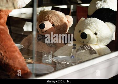 210228 -- WARSAW, Feb. 28, 2021 -- Stuffed toy bears are seen seated at a table in a pizza restaurant in Warsaw, Poland, Feb. 27, 2021. Photo by /Xinhua POLAND-WARSAW-RESTAURANT-STUFFED TOYS JaapxArriens PUBLICATIONxNOTxINxCHN Stock Photo