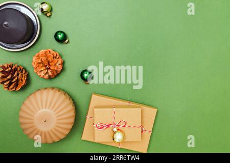 Christmas still life composition with gift boxes and candles on green background, top view Stock Photo