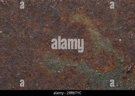 Iron oxide rust solid full frame background image. Rusted texture of a metal manhole cover with fine details with copy space. Stock Photo