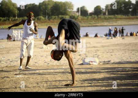 210305 -- KHARTOUM, March 5, 2021 -- People play on a beach of the Blue Nile during the weekend in Khartoum, Sudan, March 5, 2021. Photo by /Xinhua SUDAN-KHARTOUM-DAILY LIFE-WEEKEND MohamedxKhidir PUBLICATIONxNOTxINxCHN Stock Photo