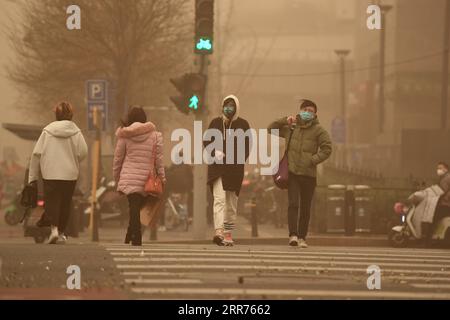 210315 -- Beijing, March 15, 2021 -- A Woman Walks In Dust In Beijing 