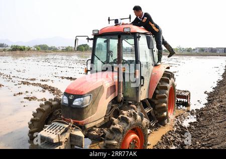 210317 -- BEIJING, March 17, 2021 -- A staff member of an eco-agriculture cooperative checks the automotive driving apparatus on a tractor in Jiaoyi Village, Taishan City of south China s Guangdong Province, March 12, 2021.  Xinhua Headlines: China s spring farming goes high-tech to ensure food security DengxHua PUBLICATIONxNOTxINxCHN Stock Photo