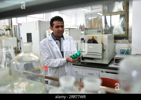 210318 -- XI AN, March 18, 2021 -- Abdul Ghaffar Shar makes preparation for an experiment at a laboratory of Northwest Agriculture and Forestry University NWAFU in Yangling, northwest China s Shaanxi Province, March 17, 2021. Abdul Ghaffar Shar, 30, is a Pakistani doctoral student in China s Northwest Agriculture and Forestry University NWAFU. Shar is doing plant nutrition research for his doctoral degree. After receiving his bachelor s degree in agriculture from Sindh Agriculture University in Pakistan in 2014, Shar decided to further his studies in China s NWAFU. Shar has learned to speak Ma Stock Photo