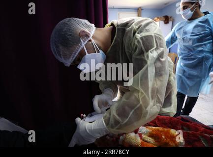 210319 -- NABLUS, March 19, 2021 -- A medical worker checks a patient at Al-Shuhada Military Medical complex for COVID-19 patients in the West Bank city of Nablus, March 19, 2021. TO GO WITH Feature: Mounting COVID-19 infections in West Bank overburden Palestinian health system Photo by /Xinhua MIDEAST-NABLUS-COVID-19-HOSPITAL AymanxNobani PUBLICATIONxNOTxINxCHN Stock Photo