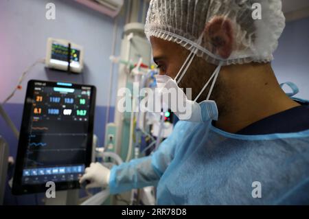 210319 -- NABLUS, March 19, 2021 -- A medical worker works at Al-Shuhada Military Medical complex for COVID-19 patients in the West Bank city of Nablus, March 19, 2021. TO GO WITH Feature: Mounting COVID-19 infections in West Bank overburden Palestinian health system Photo by /Xinhua MIDEAST-NABLUS-COVID-19-HOSPITAL AymanxNobani PUBLICATIONxNOTxINxCHN Stock Photo