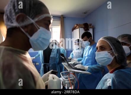 210319 -- NABLUS, March 19, 2021 -- Medical workers work at Al-Shuhada Military Medical complex for COVID-19 patients in the West Bank city of Nablus, March 19, 2021. TO GO WITH Feature: Mounting COVID-19 infections in West Bank overburden Palestinian health system Photo by /Xinhua MIDEAST-NABLUS-COVID-19-HOSPITAL AymanxNobani PUBLICATIONxNOTxINxCHN Stock Photo