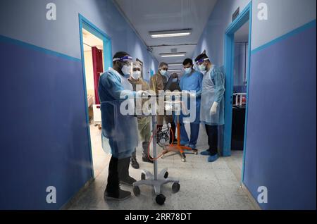 210319 -- NABLUS, March 19, 2021 -- Medical workers work at Al-Shuhada Military Medical complex for COVID-19 patients in the West Bank city of Nablus, March 19, 2021. TO GO WITH Feature: Mounting COVID-19 infections in West Bank overburden Palestinian health system Photo by /Xinhua MIDEAST-NABLUS-COVID-19-HOSPITAL AymanxNobani PUBLICATIONxNOTxINxCHN Stock Photo