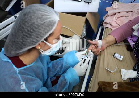 210319 -- NABLUS, March 19, 2021 -- A medical worker checks a patient at Al-Shuhada Military Medical complex for COVID-19 patients in the West Bank city of Nablus, March 19, 2021. TO GO WITH Feature: Mounting COVID-19 infections in West Bank overburden Palestinian health system Photo by /Xinhua MIDEAST-NABLUS-COVID-19-HOSPITAL AymanxNobani PUBLICATIONxNOTxINxCHN Stock Photo