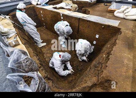 210320 -- CHENGDU, March 20, 2021 -- Archaeologists work at a sacrificial pit of the Sanxingdui Ruins site in southwest China s Sichuan Province, March 19, 2021. Chinese archaeologists announced Saturday that some new major discoveries have been made at the legendary Sanxingdui Ruins site in southwest China, helping shed light on the cultural origins of the Chinese nation. Archaeologists have found six new sacrificial pits and unearthed more than 500 items dating back about 3,000 years at the Sanxingdui Ruins in Sichuan Province, the National Cultural Heritage Administration announced in the p Stock Photo