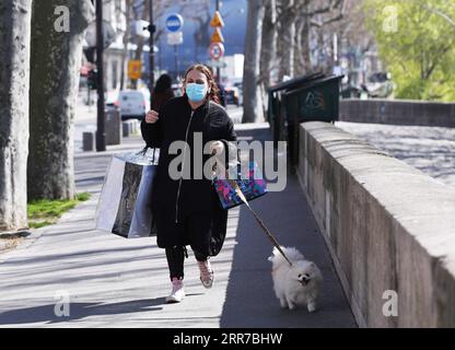 210324 -- PARIS, March 24, 2021 -- A woman walks at the Seine River banks in Paris, France, March 24, 2021. A total of 14,678 new cases were recorded over the past 24 hours, bringing the total infections in the country to more than 4.3 million. As of Tuesday evening, 26,756 patients were hospitalized for COVID-19 infection in France, including 4,634 in intensive care, according to the health authorities.  FRANCE-PARIS-COVID-19 GaoxJing PUBLICATIONxNOTxINxCHN Stock Photo