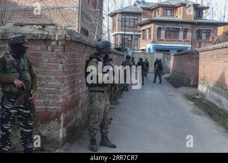 210325 -- SRINAGAR, March 25, 2021 -- Indian paramilitary troopers stand guard near the site of a militant attack in Lawaypora area of Srinagar city, the summer capital of Indian-controlled Kashmir, March 25, 2021. A paramilitary trooper belonging to India s Central Reserve Police Force CRPF was killed and three others wounded Thursday in a militant attack in restive Indian-controlled Kashmir, officials said.  KASHMIR-SRINAGAR-MILITANT ATTACK JavedxDar PUBLICATIONxNOTxINxCHN Stock Photo