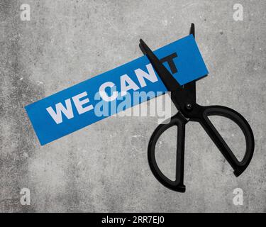 Top view we cant message card being cut with scissor Stock Photo