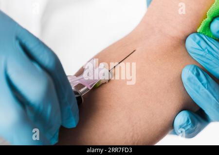 Close up doctor taking blood sample from sick person Stock Photo