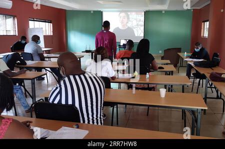 210329 -- JOHANNESBURG, March 29, 2021 -- South African tourist guides attend an online Mandarin lesson offered by the University of Johannesburg-Nanjing Technology University Confucius Institute in Pretoria, South Africa, Feb. 1, 2021. Ni wen wo ai ni you duo shen, yue lian dai biao wo de xin You asked me how much I loved you, the moon can represent my heart. When hearing this Chinese song, you can hardly believe that it was sung by a group of South African tourist guides who have been learning mandarin for only two months. These 20 tourists guides were selected from all over the country by t Stock Photo