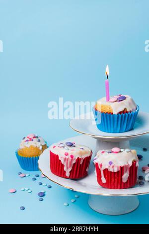Birthday cupcakes arrangement blue background Stock Photo