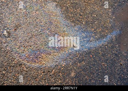 Slick industry oil fuel spilling water pollution. Water with patches of gasoline and oil. Ecological catastrophy. Stock Photo