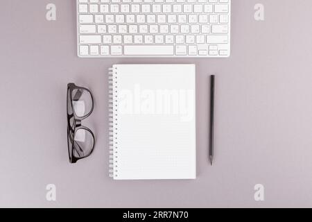 Pencil near notebook keyboard eyeglasses Stock Photo