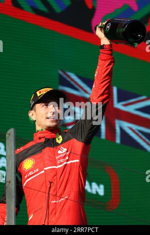Charles Leclerc of Scuderia Ferrari celebrates victory with the trophy ...
