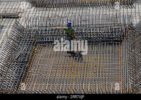 Construction workers making reinforced concrete frame in the construction site Stock Photo