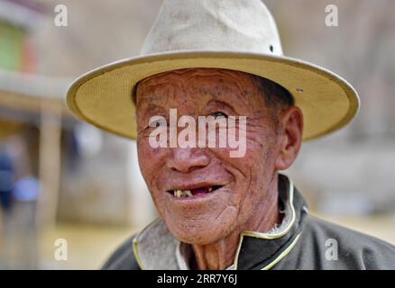 210408 -- LHASA, April 8, 2021 -- Photo taken on March 20, 2021 shows the portrait of Dro Dra in Xigaze of southwest China s Tibet Autonomous Region. Dro Dra, an 85-year-old villager in Xigaze, was once a serf in old Tibet. Back to the old time, despite the hard work all year round,Dro Dra s family could not have a grain of highland barley they grew for themselves. Year after year, they struggled in a vicious circle of borrowing food, paying taxes to the lord and returning food. Boiling water requires firewood, but every grass and tree in the manor belongs to the lord. If we were found picking Stock Photo