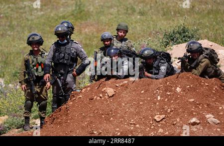 210416 -- NABLUS, April 16, 2021 -- Members of the Israeli border police and Israeli soldiers are seen during clashes following a protest against the expansion of Jewish settlements in the West Bank village of Beit Dajan, east of Nablus, on April 16, 2021. Photo by /Xinhua MIDEAST-NABLUS-CLASHES AymanxNobani PUBLICATIONxNOTxINxCHN Stock Photo