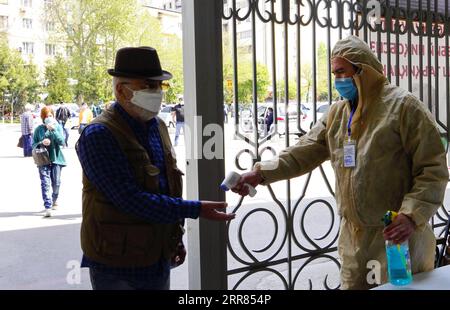 210418 -- TASHKENT, April 18, 2021 -- A man has his temperature checked at a market in Tashkent, Uzbekistan, April 18, 2021. Uzbekistan introduces new restrictions on public events, catering and transport services starting from April 18 amid surging COVID-19 infections. According to the country s special commission on combating COVID-19, cafes, restaurants and public transport must use only 50 percent of their seating capacity, and the same rules apply to public meetings, as well as any scheduled international conferences and other events. Photo by /Xinhua UZBEKISTAN-TASHKENT-COVID-19 ZafarxKh Stock Photo