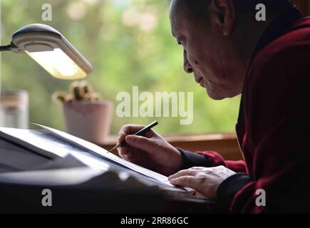 210421 -- CHENGDU, April 21, 2021 -- Li Jian works in his office at the Chengdu Institute of Biology of the Chinese Academy of Sciences in Chengdu, southwest China s Sichuan Province, on April 13, 2021. It is my duty to depict these cute animals from the best angles, with the most accurate details, and in the closest colors for the readers, said Li Jian, a 60-year-old senior experimentalist of the Chengdu Institute of Biology of the Chinese Academy of Sciences. Li has been drawing for scientific purposes since he joined the institute in 1978, during which he acquired an eagle s sight for minut Stock Photo