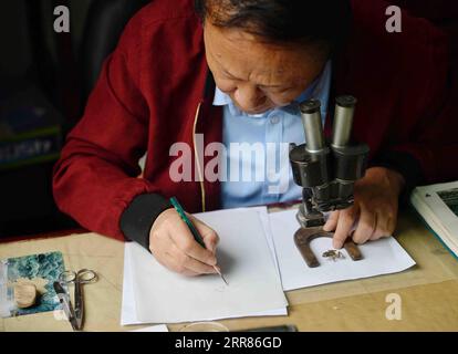 210421 -- CHENGDU, April 21, 2021 -- Li Jian works in his office at the Chengdu Institute of Biology of the Chinese Academy of Sciences in Chengdu, southwest China s Sichuan Province, on April 13, 2021. It is my duty to depict these cute animals from the best angles, with the most accurate details, and in the closest colors for the readers, said Li Jian, a 60-year-old senior experimentalist of the Chengdu Institute of Biology of the Chinese Academy of Sciences. Li has been drawing for scientific purposes since he joined the institute in 1978, during which he acquired an eagle s sight for minut Stock Photo