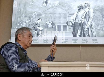 210423 -- CHENGDU, April 23, 2021 -- Yang Wuneng checks his official WeChat account at home in southwest China s Chongqing Municipality, April 18, 2021. In a career that spans over 60 years, Yang Wuneng has translated 31 German classics into the Chinese language, including Faust , Selected Poems of Heinrich Heine and Immensee. Many of his translations are still bestselling books in some bookstores. His translation of Grimms Fairy Tales, for instance, has been popular among Chinese readers for many generations. Today, Yang is still an active figure in the literary and translation circle. He als Stock Photo