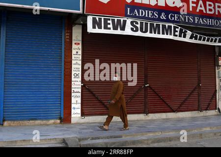 210424 -- RAWALPINDI, April 24, 2021 -- A man wearing a face mask walks past closed shops during restrictions to control the spread of COVID-19 in Rawalpindi of Pakistan s Punjab province, April 24, 2021. Pakistani Prime Minister Imran Khan on Friday urged the Pakistani people to wear masks in public and follow the other standard operating procedures SOPs set by the government to control the virus spread and stop the third wave of COVID-19 from getting worse.  PAKISTAN-RAWALPINDI-COVID-19-RESTRICTIONS AhmadxKamal PUBLICATIONxNOTxINxCHN Stock Photo