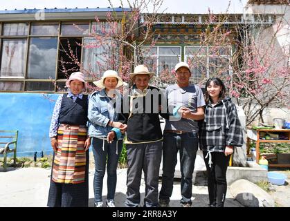 210427 -- LHASA, April 27, 2021 -- Lhapu C poses for a group photo with his family members in Lin a Village of Dagze County in Lhasa, southwest China s Tibet Autonomous Region, April 25, 2021. Lhapu, born in 1938, worked as a serf before the democratic reform in Tibet in 1959, which abolished its feudal serfdom under theocracy. As part of the production tools, we just did what the lord asked us to do, and were even forbidden to speak loudly, Lhapu recalled his life in the old times, adding that children had no guaranteed food and clothing. After the democratic reform, great changes have taken Stock Photo