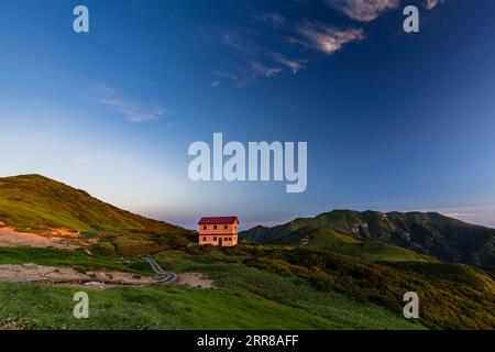 Asahi Mountain Range, morning glow, Kitsuneana shelter hut and Mt.Itoh(Itohdake),100 mountains of Japan, Yamagata, Tohoku, Japan, Asia Stock Photo