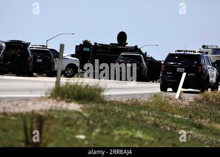 210428 -- LOS ANGELES, April 28, 2021  -- Police officers investigate at the scene where the gunman was killed in Fullerton shootout in Los Angeles, California, the United States, April 27, 2021. A gunman, suspected of killing two and wounding another in a series of drive-by shooting incidents in Los Angeles, was killed by police Tuesday morning after about five hours chase and exchange of fire. According to Raul Jovel, an officer from the Los Angeles Police Department LAPD s Media Relations Division, the shooter s rampage occurred from 0:55 a.m. to 1:25 a.m. local time, when he drove a white Stock Photo