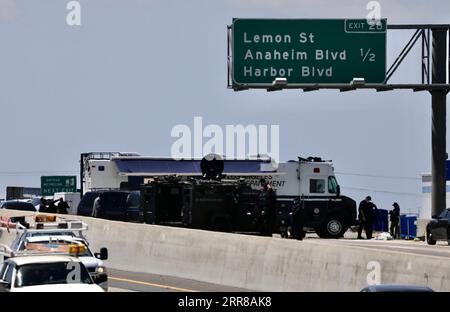 210428 -- LOS ANGELES, April 28, 2021  -- Police officers investigate at the scene where the gunman was killed in Fullerton shootout in Los Angeles, California, the United States, April 27, 2021. A gunman, suspected of killing two and wounding another in a series of drive-by shooting incidents in Los Angeles, was killed by police Tuesday morning after about five hours chase and exchange of fire. According to Raul Jovel, an officer from the Los Angeles Police Department LAPD s Media Relations Division, the shooter s rampage occurred from 0:55 a.m. to 1:25 a.m. local time, when he drove a white Stock Photo