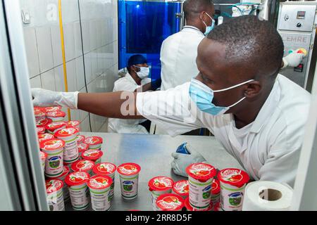 210502 -- NYANZA, May 2, 2021 -- An employee of Zirakamwa Meza Dairy arranges yogurt in Nyanza district, about a two-hour drive from the Rwandan capital city Kigali, on April 30, 2021. TO GO WITH Feature: From genocide widow to successful businesswoman -- Rwandan woman walking out of shadow photo by /Xinhua RWANDA-NYANZA-GENOCIDE-BUSINESS WOMAN CyrilxNdegeya PUBLICATIONxNOTxINxCHN Stock Photo