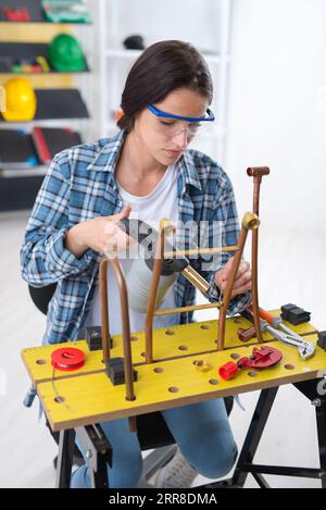 a young woman using blowtorch Stock Photo