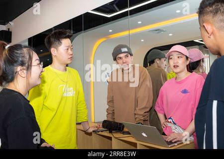 210504 -- URUMQI, May 4, 2021 -- Xirli Abdukirm 3rd L and his colleagues Dou Jiayang 1st L, Wang Xiaowu 2nd L and Ma Jie 1st R communicate while making tutorial videos at a street dance studio in Urumqi, northwest China s Xinjiang Uygur Autonomous Region, April 27, 2021. Just like in Beijing, Shanghai and other big cities in China, street dance has become increasingly popular among the youngsters in Urumqi, capital city of Xinjiang. A growing number of college graduates have taken street dance teaching as their profession and 25-year-old Xirli Abdukirm is one of them. Xirli, who has been pract Stock Photo