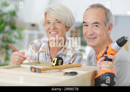 happy older couple holding diy tools Stock Photo