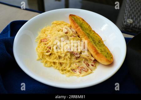 Creamy Carbonara Pasta with Garlic Bread Stock Photo