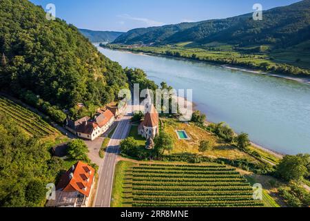 Aerial view of the Danube river and the town of Tulcea with lush green ...