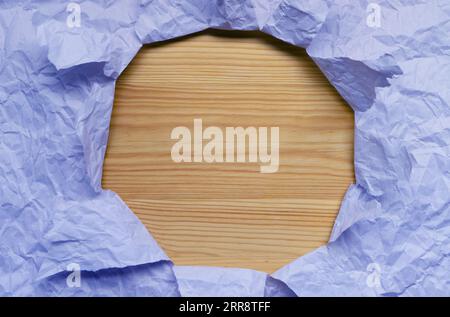Frame of Light Blue Ripped Paper with Light Brown Wooden Copy Space Stock Photo