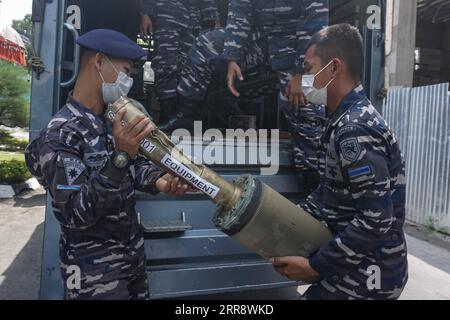 210519 -- DENPASAR, May 19, 2021 -- Indonesian Navy officers carry parts of the sunken Indonesian Navy submarine KRI Nanggala-402 after a press conference in Denpasar, Bali, Indonesia, May 18, 2021. The Indonesian Navy, with the assistance of China s People s Liberation Army Navy, has managed to lift a life raft and other fragments belonging to the sunken Indonesian submarine KRI Nanggala-402 in the Bali waters. Photo by /Xinhua INDONESIA-DENPASAR-SUNKEN SUBMARINE-SALVAGE-PRESS CONFERENCE Bisinglasi PUBLICATIONxNOTxINxCHN Stock Photo