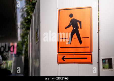 Pedestrian crossing sign under construction with orange color Stock Photo