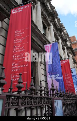 Banners outside Burlington House, including The Royal Academy Summer Exhibition, London, UK. Stock Photo